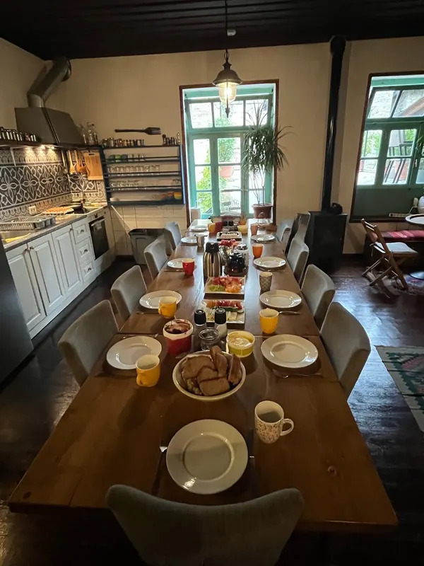 Breakfast laid out on the long shared table in the kitchen