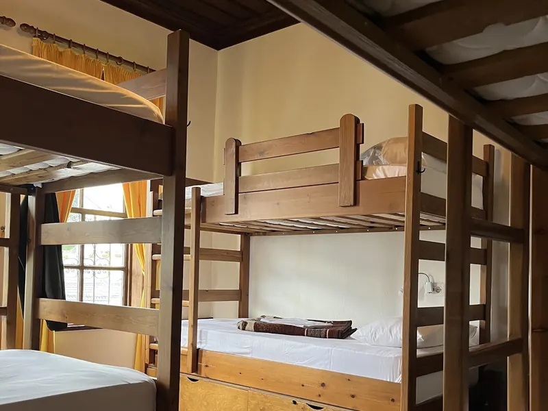 Wooden bunk beds in a dorm